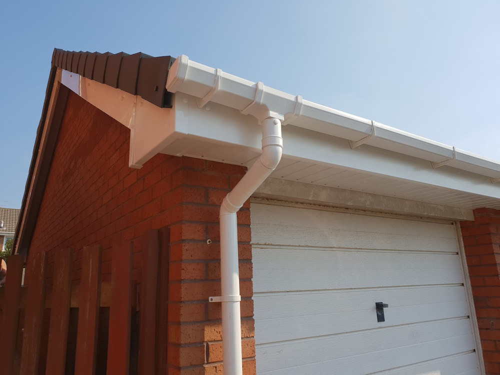 White fascia, soffit and guttering along a house